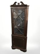 A reproduction mahogany corner cabinet, height 192 cm.