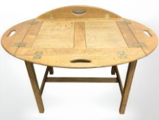 An oak butlers tray table on stand, width 60 cm.