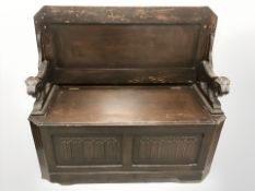 An oak linen fold monks bench, 110 cm wide.