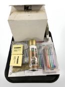 A group of stationary including pens and mechanical pencils, sticky notes, diary,