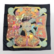 A Hermes silk scarf 'Art Des Steppes', together with gold plated Hermes scarf clip,