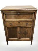 An early 20th century oak cabinet,