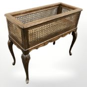An early 20th century beech and cane work planter on cabriole legs, width 73 cm.