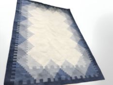 A flat weave kilim carpet on blue ground,