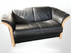 A contemporary Danish wooden framed black leather two seater settee,