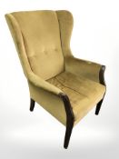 An early 20th century continental armchair in olive coloured fabric
