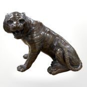 A Japanese bronze figure of a tiger, realistically cast in seated pose with jaws agape, height 17cm.