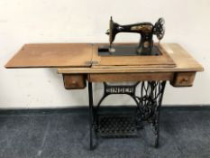 A Singer treadle sewing machine in oak table.