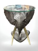 A contemporary cast and patinated metal elephant coffee table, with circular glass top,
