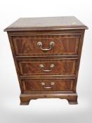 A reproduction three drawer low chest,