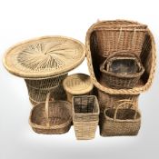 A wicker chair, circular table and several baskets.