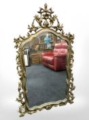 An ornate gilt reproduction mirror, 142 cm x 80 cm.