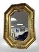 An octagonal gilt mirror, 60 cm x 44 cm.