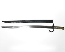 A French Remington sabre bayonet with brass hilt and steel scabbard, blade 57 cm,