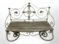 A wrought and painted metal garden bench,