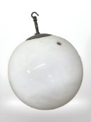 A 20th century opaque glass globular light shade with metal hanger, diameter 31 cm.