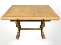 A 20th century oak pull out refectory dining table,