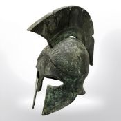 A miniature bronze Greek hoplite helmet, height 15 cm.