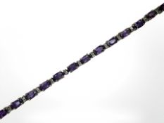 A 14ct gold amethyst and diamond line bracelet,