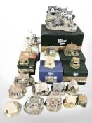 Nineteen Lilliput Lane cottages, nine with boxes.