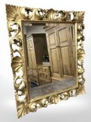 A Florentine-style gilt plaster mirror, 65 cm x 56 cm.