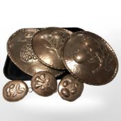 A group of 19th century embossed copper plaques, largest 39 cm long.