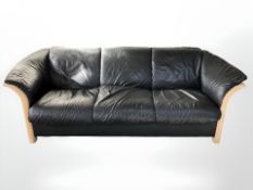 A contemporary Danish wooden framed black leather three seater settee,