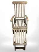 A brass mounted teak garden lounger.