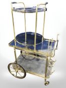 A continental brass framed trolley and similar two tier table