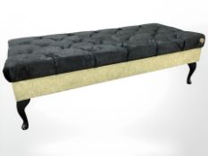 A contemporary low seat/day bed in buttoned faux velvet upholstery,