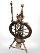 A 19th century spinning wheel. CONDITION REPORT: Historic woodworm throughout.