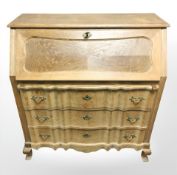 A 20th century continental oak serpentine front bureau, 96 cm x 46 cm x 104 cm.