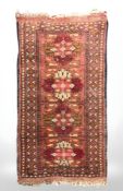An Afghan rug, 115 cm x 55 cm.