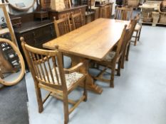 A contemporary ash 7 ft refectory dining table and matching set of eight dining chairs.