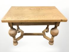 An early 20th century oak refectory coffee table on turned bulbous supports, width 77 cm.