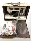 A Jones electric sewing machine with lead and pedal, roll of floral upholsterer's fabric,