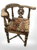 A carved beech corner armchair.
