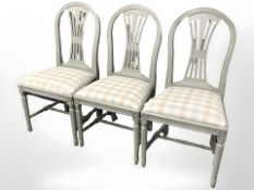 A set of six reproduction painted dining chairs.