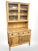 A reproduction oak bookcase fitted cupboards and drawers,