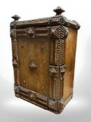 A 19th century Dutch chip carved pine single door cabinet, height 52 cm.
