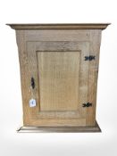 A 20th century blonde oak single door wall cabinet, 53 cm x 25 cm x 63 cm.