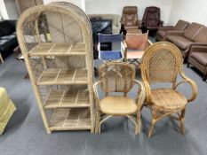 Two wicker armchairs and a similar open bookcase,