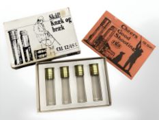 Four glass 'cartridge' whisky flasks, boxed.