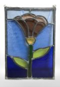 A contemporary stained and leaded glass floral decorated panel,
