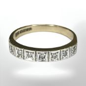A 9ct gold half-eternity ring with seven illusion-set diamonds,