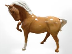 A Beswick Horse 1549 (Head Tucked, Leg Up), palomino, first version, height 19.1cm.
