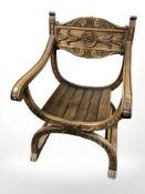 A carved beech savonarola-style armchair, width 63 cm.