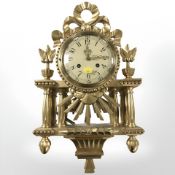 A reproduction Swedish gilt wall clock, signed Westerstrand, with pendulum and key, height 54 cm.