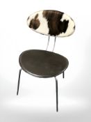 A vinyl and cowhide upholstered chrome chair.