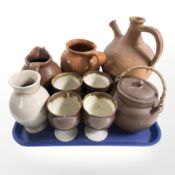 A group of terracotta jugs, teapot, set of four earthenware goblets, etc.
